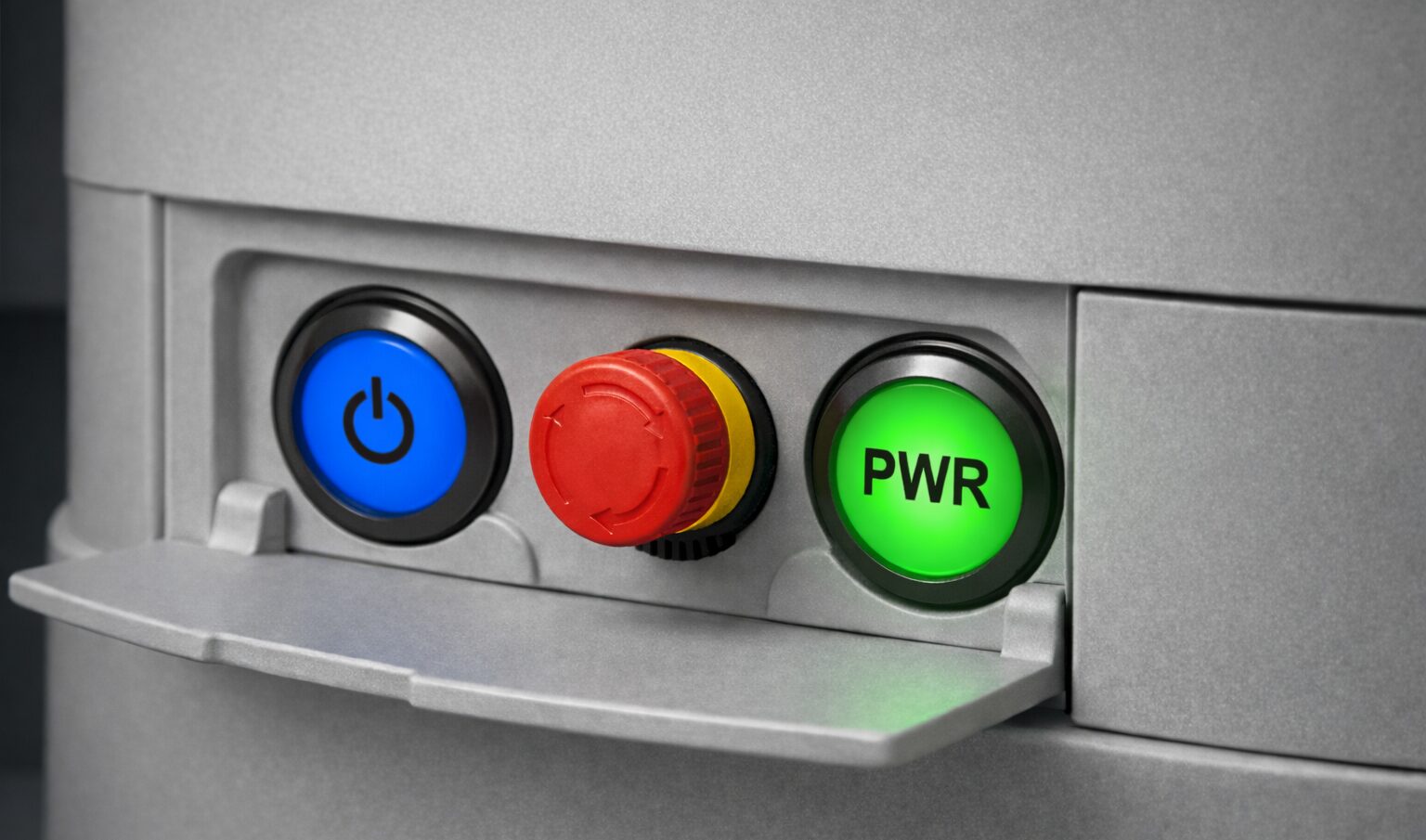 Recessed humanoid robot control panel featuring illuminated pushbuttons for supervised state transitions and a low profile emergency stop button (E-Stop switch) for immediate hardware-level stop authority.